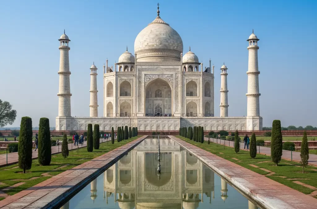 “Taj Mahal in Agra, white marble monument reflecting in the Yamuna River under a clear blue sky”