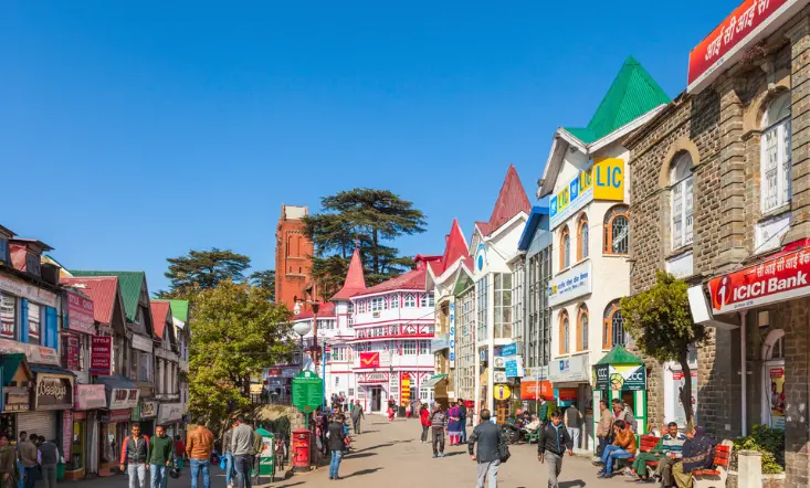 Mall Road market street lined with local shops and visitors enjoying an evening walk.