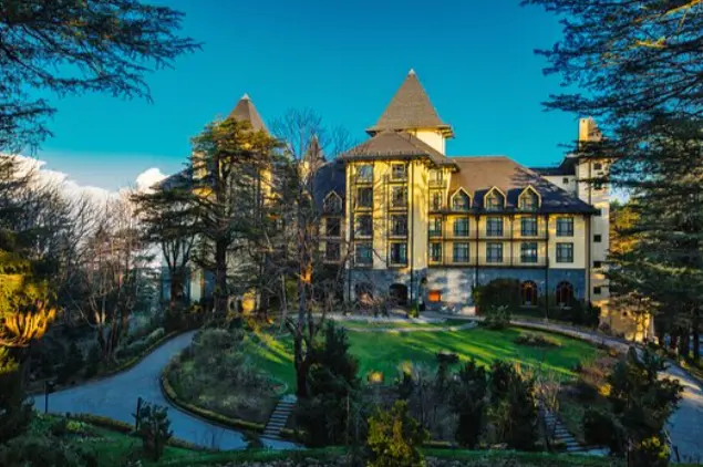“Exterior view of The Oberoi Cecil Shimla heritage hotel with landscaped gardens and mountain surroundings”
