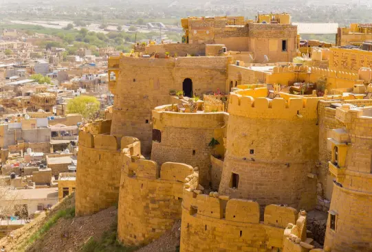Jaisalmer Fort glowing in golden sandstone under bright blue sky